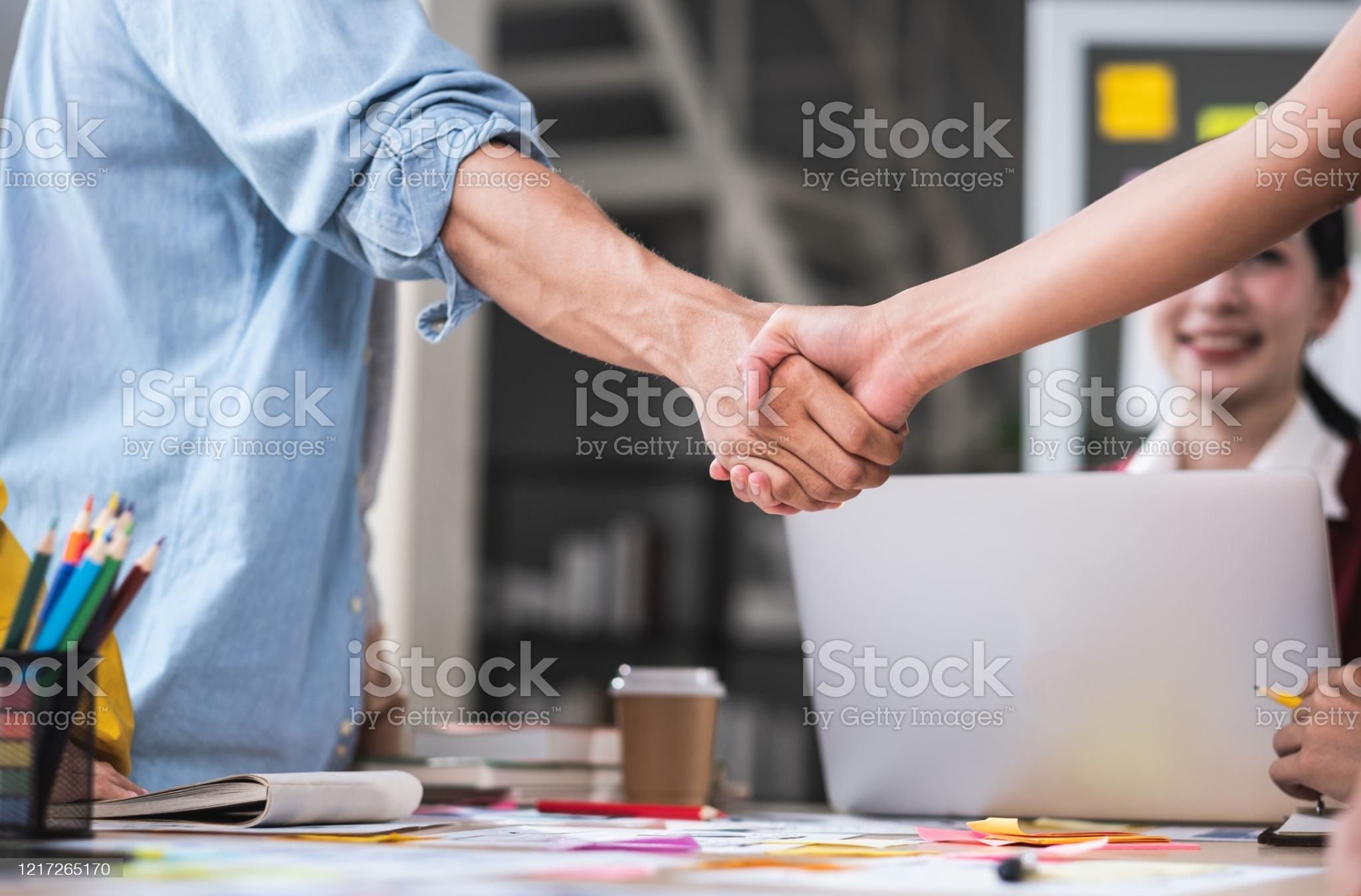 close up handshaking of ux developer and ui designer deal with contract partnership over meeting table in boardroom at modern office.congratulation handshaking for job promotion